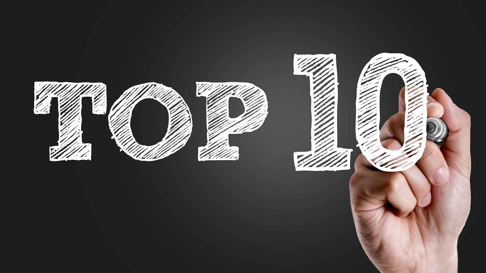 Image of a Hand writing the text: Top 10