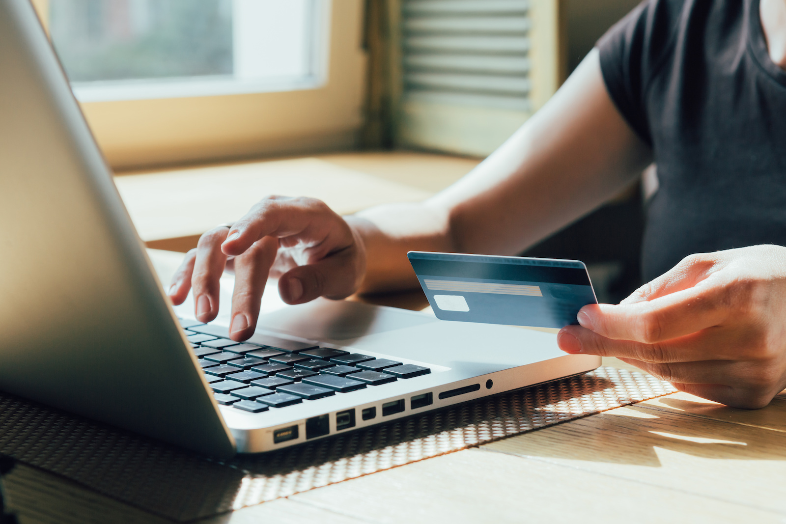 Image of a women paying with a credit card online.