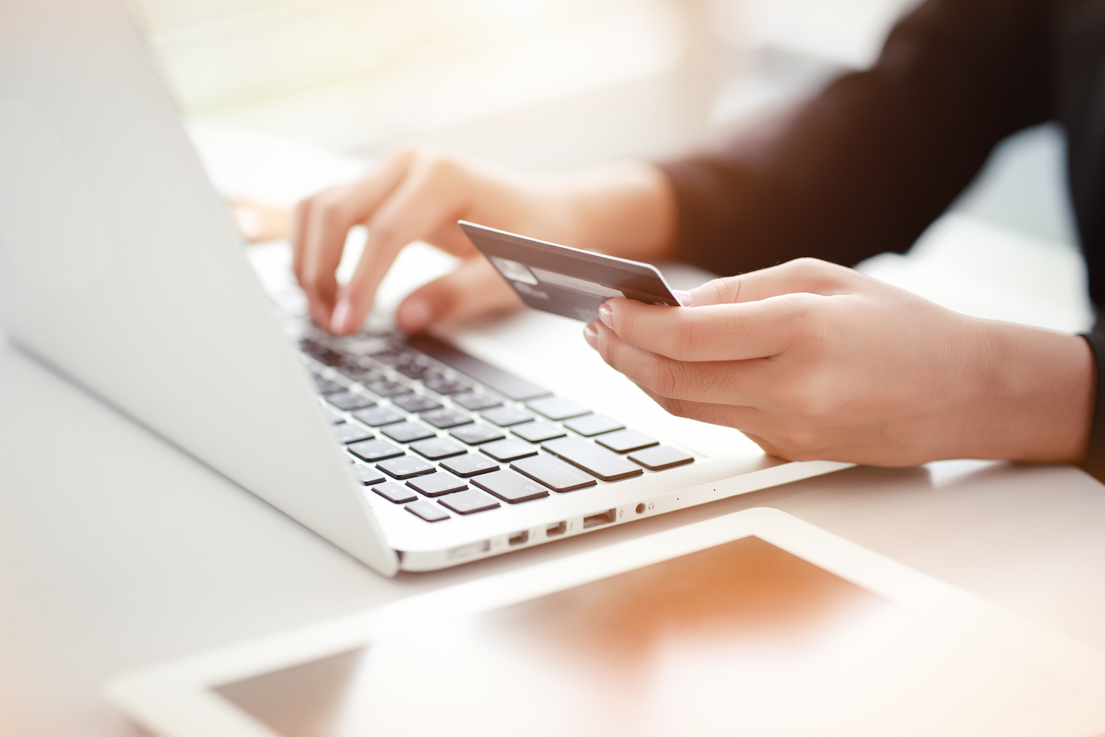 Image of a women paying online with a credit card.