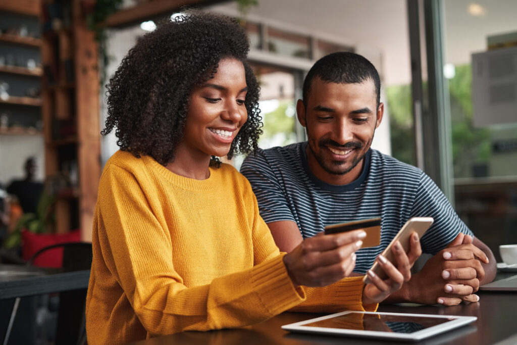 image of a couple online shopping with a credit card.