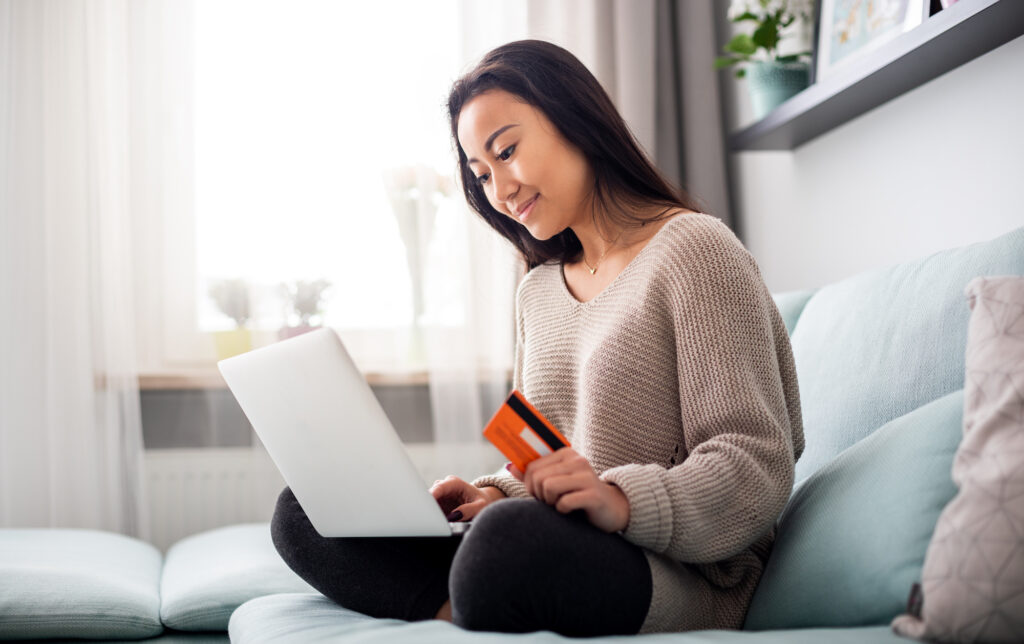 Image of a women shopping online using a credit card.