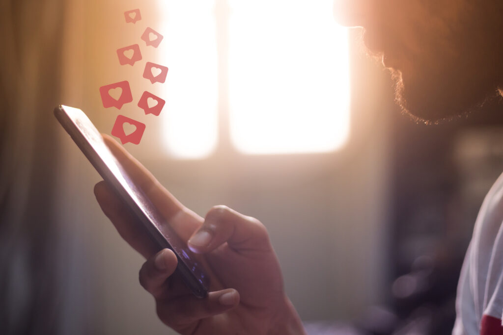 Image of a man using social media for his business on a smart phone.