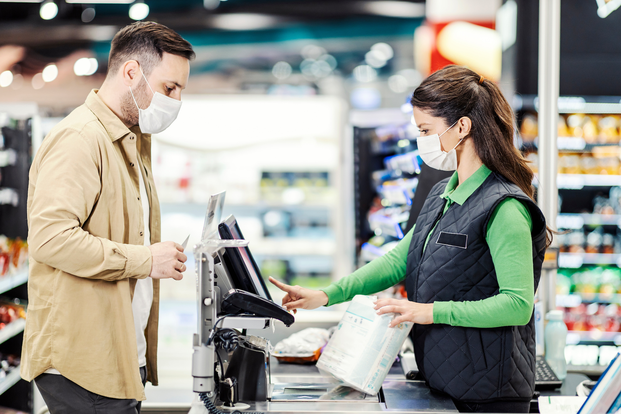 Image of a customer paying at a store during the pandemic.