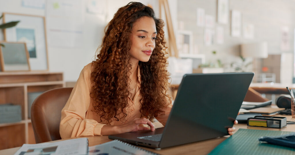 Image of a business owner using a laptop for online payment processing.